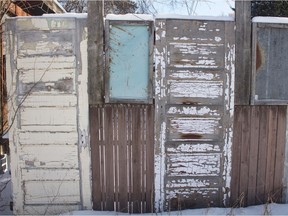 Fence made out of doors in a Saskatoon back alley.