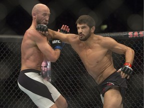 Patrick Cote (right) connects with Josh Burkman at UFC Fight Night in Saskatoon on Aug. 23, 2015