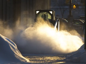 File Photo. Snow clearing at sunrise along the sidewalks to the south end of Midtown Plaza, February 25, 2015 (GordWaldner/TheStarPhoenix)