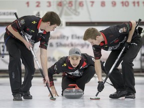 File Photo. Team Springer members skip Garret Springer looks on as second Drew Springer, right, and lead Grady Lamontagne sweep  against Team Hersikorn during the  Junior Men's Provincial curling championship at the Nutana Curling Club.