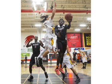 Archbishop O'Leary Spartans' Mina Ogot (R) takes a shot against the Garden City Collegiate Fighting Gophers at the annual BRIT basketball classic, January 9, 2016.