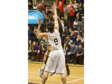 Archbishop O'Leary Spartans' Adong Makuoi takes a shot against the Garden City Collegiate Fighting Gophers at the annual BRIT basketball classic, January 9, 2016.