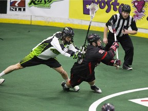 Saskatchewan Rush #16 Chris Corbell knocks down  Vancouver Stealth#55 Joel McCready in the defensive zone  in the Rush's first game at SaskTel Centre bringing national league lacrosse to Saskatoon,  January 15, 2016.