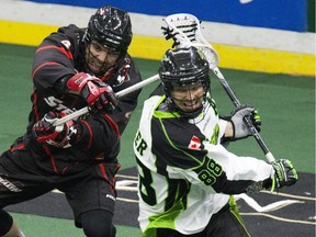 Saskatchewan Rush  Zack Greer is given a swat from behind by a  Vancouver Stealth defender in the Rush's first game at SaskTel Centre bringing National Lacrosse League action to Saskatoon.