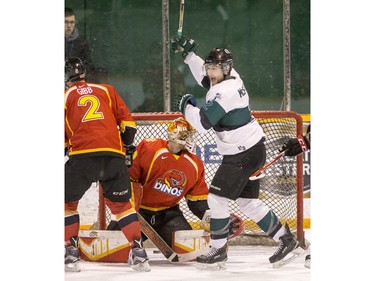 University of Saskatchewan defence Kendall McFaull celebrates a goal in front of University of Calgary Dinos goalie Steven Stanford in CIS men's hockey action, January 16, 2016.