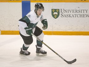 University of Saskatchewan defenceman Jesse Forsberg moves the puck against the University Calgary Dinos in CIS men's hockey action.