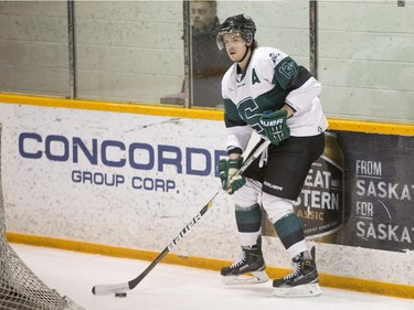 University of Saskatchewan defence  Zak Stebner moves the puck against the University of Calgary Dinos in CIS men's hockey action, January 16, 2016.