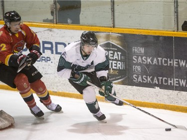 University of Saskatchewan forward  Kohl Bauml moves the puck against the University of Calgary Dinos in CIS men's hockey action, January 16, 2016.