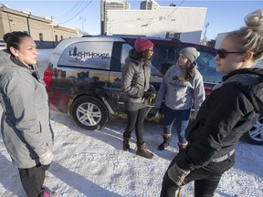 Lighthouse outreach support worker, Christine Chechosis, left, speaks with workers during a shift change at the Lighthouse on Sunday, Jan. 17, 2016.