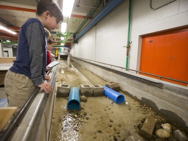 Children look on during a water flow demonstration at Spectrum at the College of Engineering of the University of Saskatchewan campus on January 17, 2016.