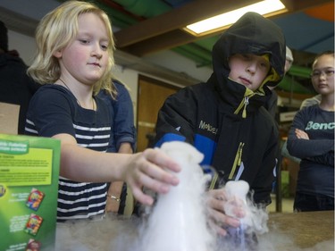 Lewis Hunt, age 10, and Audra Babyak, age nine, check out a demonstration with dry ice at Spectrum at the College of Engineering of the University of Saskatchewan campus on January 17, 2016.