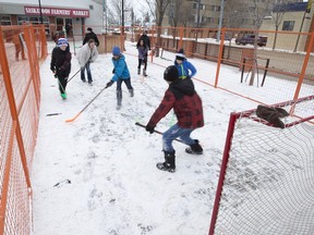 A shinny game is being played by visiting schoolchildren in a confined area at the Saskatoon Farmers' Market Wintershines site, January 25, 2016.