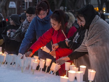 People light candles at a candlelight vigil that was held in Saskatoon at the Vimy Memorial honouring those killed in La Loche during a tragic mass-shooting at a home and the community's high school that claimed the lives of four people and left several others injured.