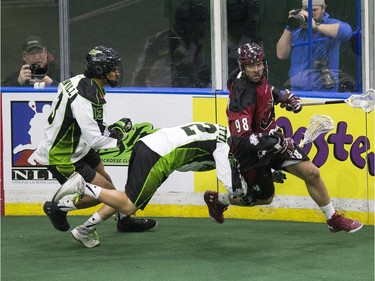 Saskatchewan Rush's Adrian Sorichetti and  Jeff Cornwall can't chase down Colorado Mammoth's Callum Crawford in Lacrosse action at SaskTel Centre, January 29, 2016.