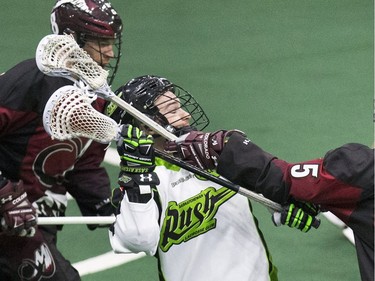 Saskatchewan Rush player Mark Matthews is roughed up by the Colorado Mammoth's defence in Lacrosse action at SaskTel Center,  January 29, 2016.