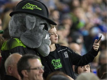 A Saskatchewan Rush fan gets a selfie with the mascot, January 29, 2016.