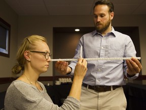 Cam Marshall, left, who focuses on concussion research, uses a Convergence Test on Ainsley Oliver, an employee of Craven Sport, during a seminar on concussion treatments at Park Town Hotel on Jan. 30, 2016.