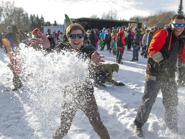 Brandon Daouste (L) throws a pile of snow during an attempt to break the world record for the world's largest snowball fight on January 31, 2016.