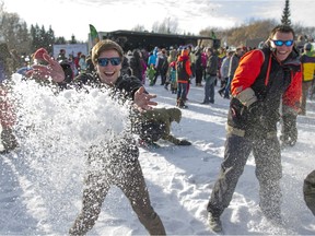 Brandon Daouste (left) throws a pile of snow during an attemt to break the world record for the worlds largest snowball fight on Sunday, January 31, 2016. (Kayle Neis/Saskatoon StarPhoenix)