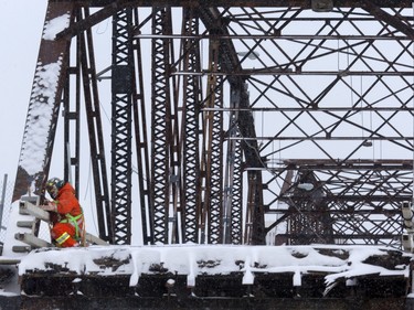 A worker used a torch to hack away at the old Traffic Bridge in preparation for demolition, January 7, 2016.
