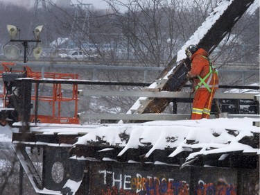 A worker used a torch to hack away at the old Traffic Bridge in preparation for demolition, January 7, 2016.