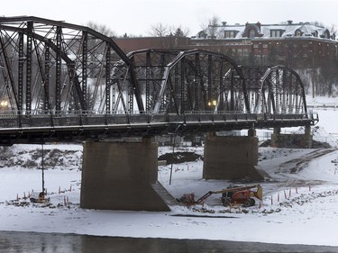 Surveyors work inside the safety perimeter of the Traffic Bridge, January 8, 2016. The area will be blocked off to pedestrian traffic Sunday morning because explosive charges are being laid for the demolition of the bridge.