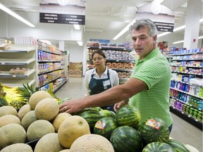 Station 20 West groceries manager Ralph Winterhalt and employee Tara Merasty celebrated the opening of the store in September 2012