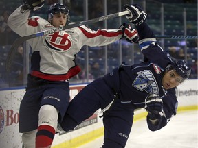 Darian Skeoch of the Lethbridge Hurricanes, left, collides with Terrell Draude of the Saskatoon Blades during Western Hockey League action at SaskTel Centre in Saskatoon, Dec. 16, 2015.