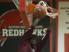 Adong Makuoi, of the Archbishop O'Leary Spartans, dunks the ball in warmups at the annual BRIT basketball classic.