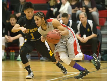 Justyn Lightle of the Bedford Road Collegiate RedHawks (R) goes around the defence of Christian De Leon of the Garden City Fighting Gophers during opening game action in the annual BRIT basketball classic, January 7, 2016.