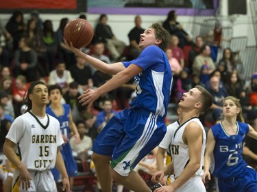 Luke Karwacki of the Bishop James Mahoney Saints, blue, goes for drive against Cole Penner of the Garden City Fighting Gophers during the annual BRIT basketball classic  Friday, January 08, 2016.