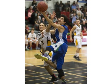 Taijal Verma of the Bishop James Mahoney Saints, blue, goes for the rebound with Marcel Arruda-Welch of the Garden City Fighting Gophers during the annual BRIT basketball classic  Friday, January 08, 2016.