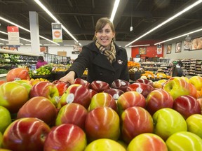 Cassandra Touet, a public health nutritionist, with fresh foods at the Co-op on 33rd Street West in Saskatoon,   Jan. 20, 2016.