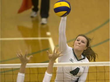 U of S Huskies' Taylor Annala (top) hits the spike against Jenna Smith of the Mount Royal Cougars at the PAC,  January 22, 2016.