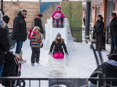 Children take advantage of an ice slide at the PotashCorp Wintershines Festival in Saskatoon, January 23, 2016.