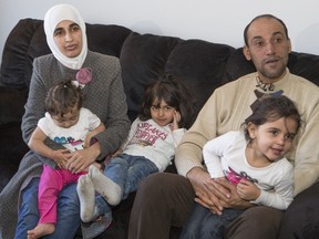 Father Basem Husain Ahmad and mother Fadi Al Masalma are refugees from Syria and spoke to media with their three children, Taima Basem Ahmad (4 1/2), middle, Bara'A Basem Ahmad, and Rehal Basam Ahmad (youngest at left) in Saskatoon, Friday, Jan. 29, 2016.