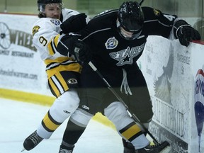 Jason Duret of Estevan Bruins, left, fights for the puck with Ryan Rosenberg of the Battlefords North Stars in SJHL showcase action at the Legends Arena in Warman.