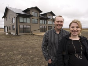 Ryan and Pam Jansen in 2012 at their net-zero energy home that uses solar and geothermal power.