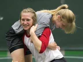 Silke Svenkeson, in grey shirt,  is a leader for Saskatchewan, which is ranked No. 2 nationally in Canadian Interuniversity Sport women’s wrestling.