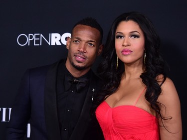Marlon Wayans and Kali Hawk pose upon arrival for the premiere of "Fifty Shades of Black" in Los Angeles, California, January 26, 2016.