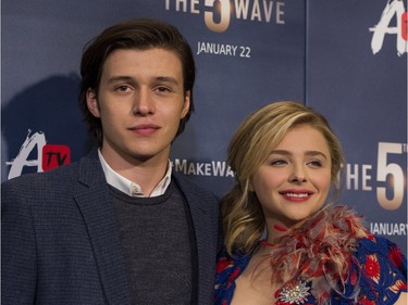 Actors Nick Robinson (L) and Chloë Grace Moretz attend "The 5th Wave" premiere at the Pacific Theatres at The Grove in Los Angeles, California, January 14, 2016.