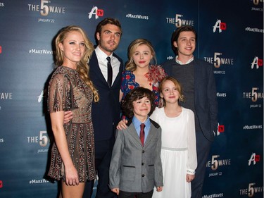 L-R: Maika Monroe, Alex Roe, Zackary Arthur, Chloë Grace Moretz, Tabitha Bateman and Nick Robinson attend "The 5th Wave" premiere at the Pacific Theatres at The Grove in Los Angeles, California, January 14, 2016.