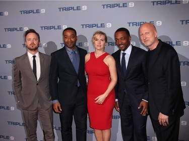 L-R: Aaron Paul, Chiwetel Ejiofor, Kate Winslet, Anthony Mackie and John Hillcoat pose for photographers upon arrival at the premiere of "Triple 9" in London, England, February 9, 2016.