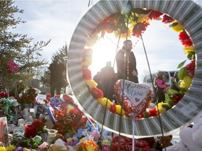 NDP Leader Tom Mulcair looks at a memorial outside the La Loche Communinty High School on Tuesday, February 2nd, 2016.