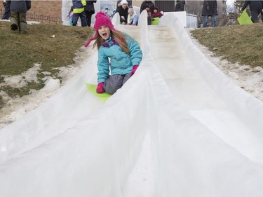 Seven-year-old Nevaeh Bitz slides down an ice slide at Frosted Gardens on the Bessborough Hotel grounds, February 6, 2016.