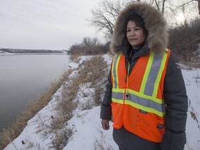 Glenda Abbott, and other members of a search party examine the shore line along the South Saskatchewan river near Meewasin Park by Spadina Crescent East and Pinehouse Drive for of Abbott's missing half brother Justin Cory Kishayinew, age 22, on Sunday, February 21st, 2016. (Liam Richards/Saskatoon StarPhoenix)