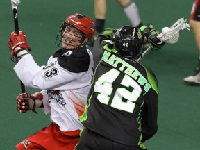 Saskatchewan's Mark Matthews intersects with Calgary's Jon Harnett during NLL action Sunday.