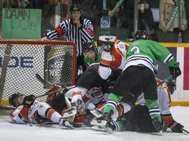 University of Saskatchewan Huskies and University of Calgary Dinos swarm the Dinos' net in CIS Men's Hockey playoff action at Rutherford rink on the U of S campus, February 27, 2016.