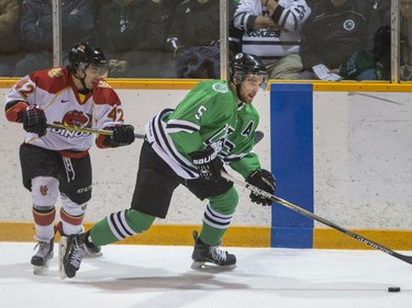 University of Saskatchewan Huskies defence Jesse Forsberg moves the puck away from University of Calgary Dinos forward Dylan Walchuk in CIS Men's Hockey playoff action at Rutherford rink on the U of S campus, February 27, 2016.