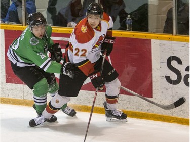 University of Saskatchewan Huskies forward Parker Thomas battles for the puck with University of Calgary Dinos forward  Mitch Cook in CIS Men's Hockey playoff action at Rutherford rink on the U of S campus, February 27, 2016.